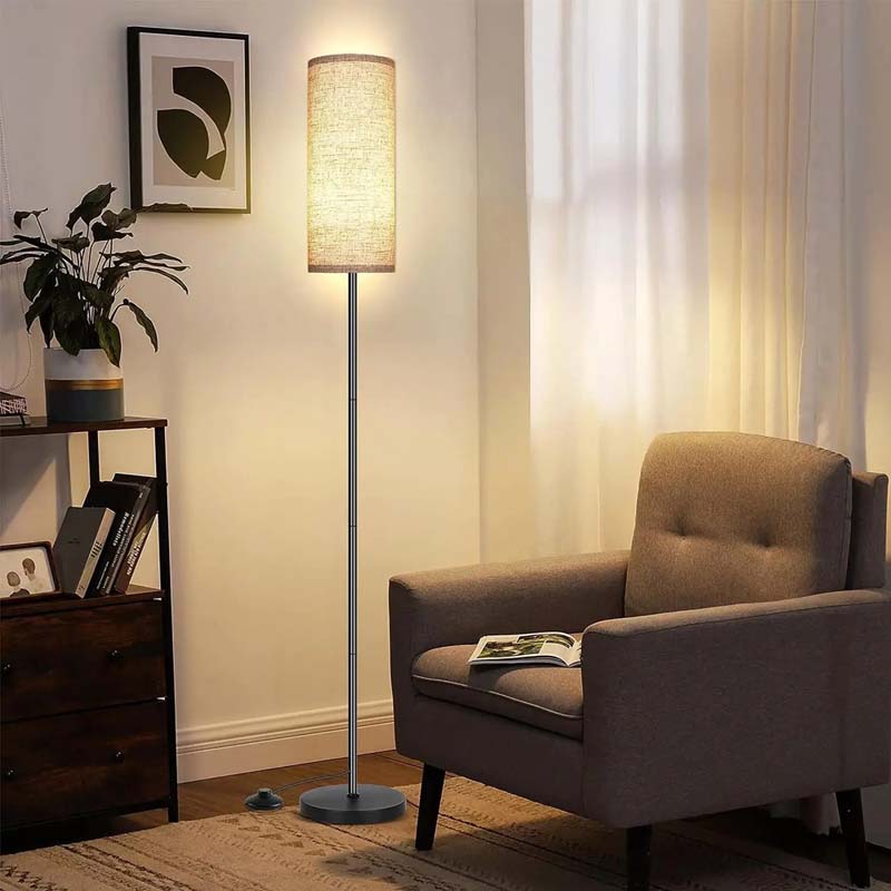 Living room with a floor lamp, armchair, and plant