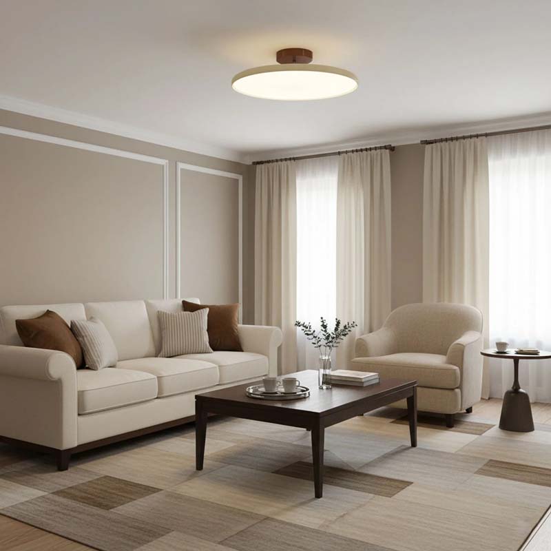 Adjustable Ceiling Light Pivot in a living room with a beige sofa, armchair and coffee table.