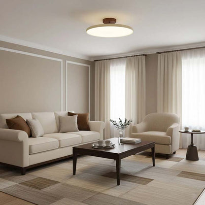 Adjustable Ceiling Light Pivot in a living room with a beige sofa, armchair and coffee table.