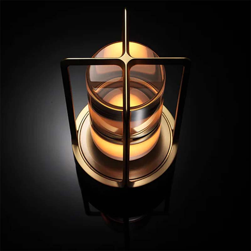 Decorative candle holder with glass and metal design on a dark background