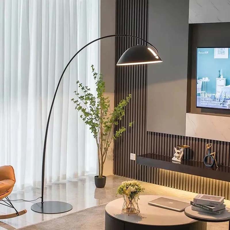 Arc floor lamp Bowl, black, with a hemispherical shade in a modern living room.