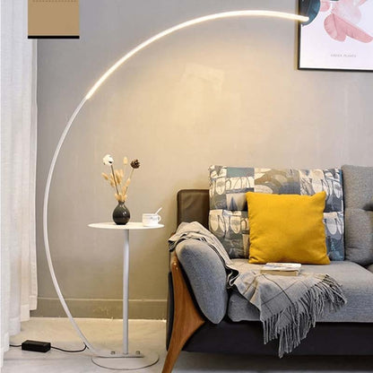 Arc floor lamp in a modern living room with a gray sofa and a yellow cushion