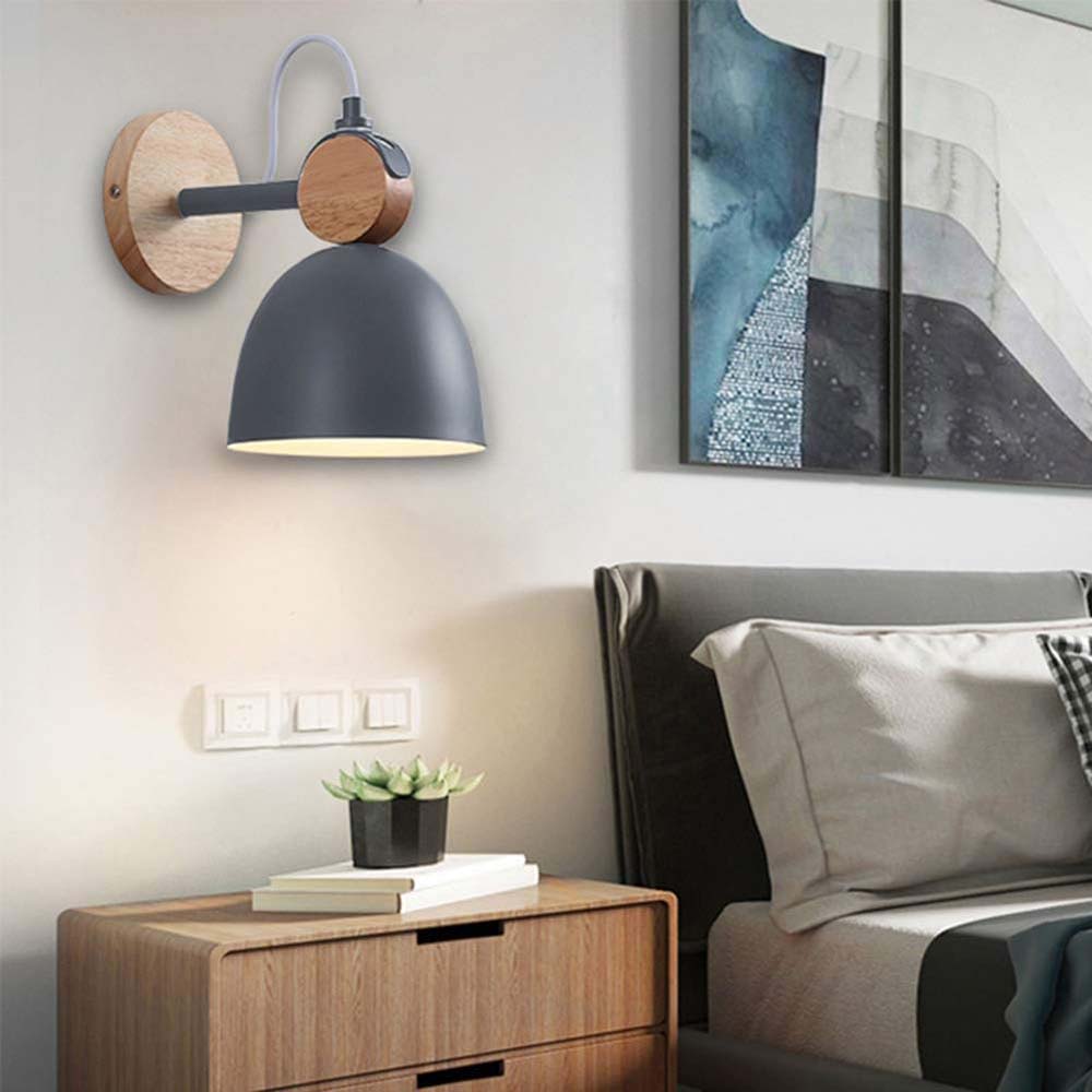 Modern bedroom with wooden nightstand, wall lamp, and abstract art on the wall.