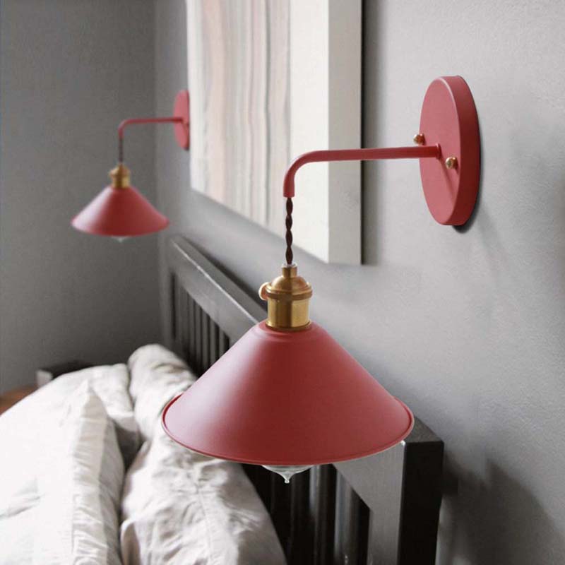 Red wall sconces on a gray wall with a window in the background