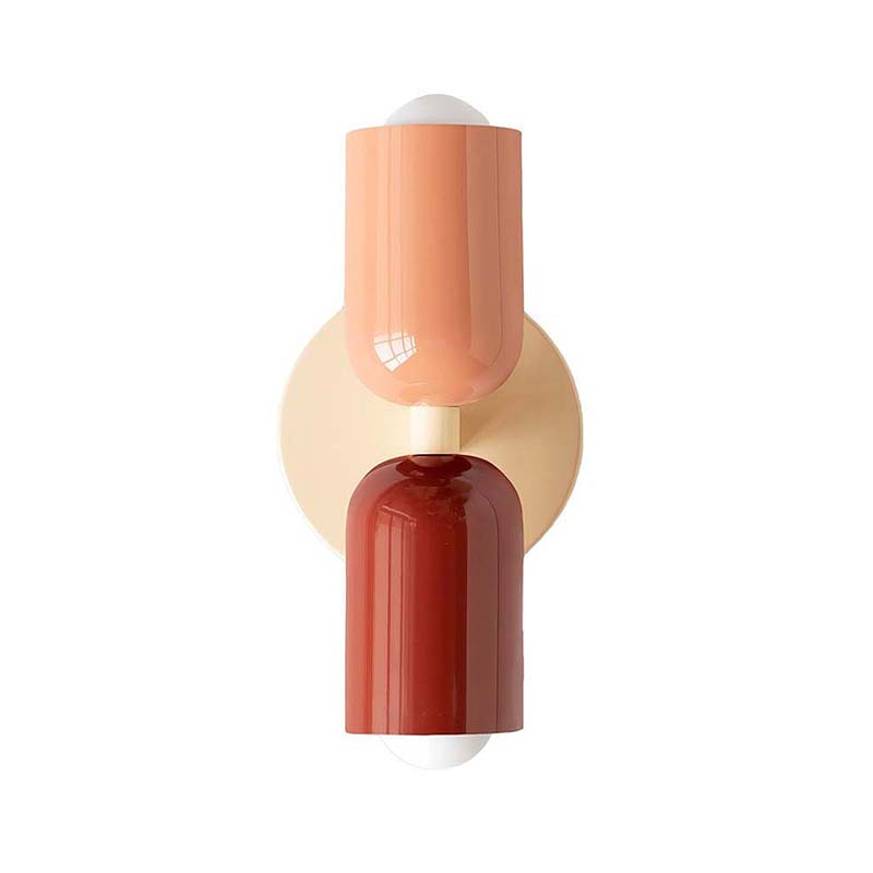 Modern wall sconce with three cylindrical segments in peach, beige, and red on a white background
