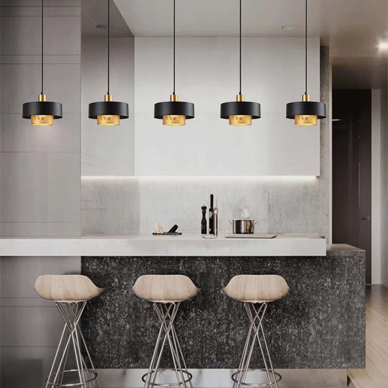 Black & Gold Pendant Lights in a modern kitchen with bar stools and an elegant design.