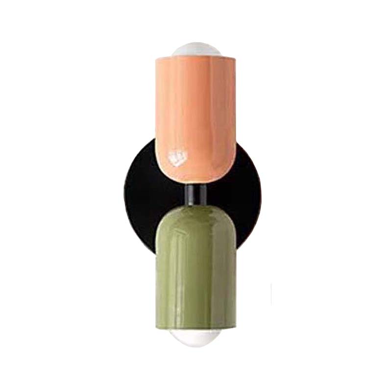 Decorative wall sconce with peach, black, and green design on a white background