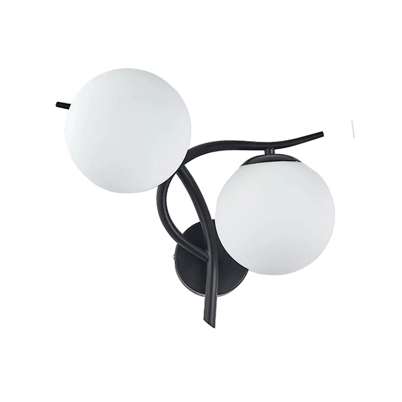 Wall-mounted light fixture with two spherical glass shades on a white background
