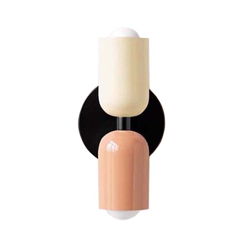 Wall sconce with two cylindrical shades, one beige and one peach, on a white background.