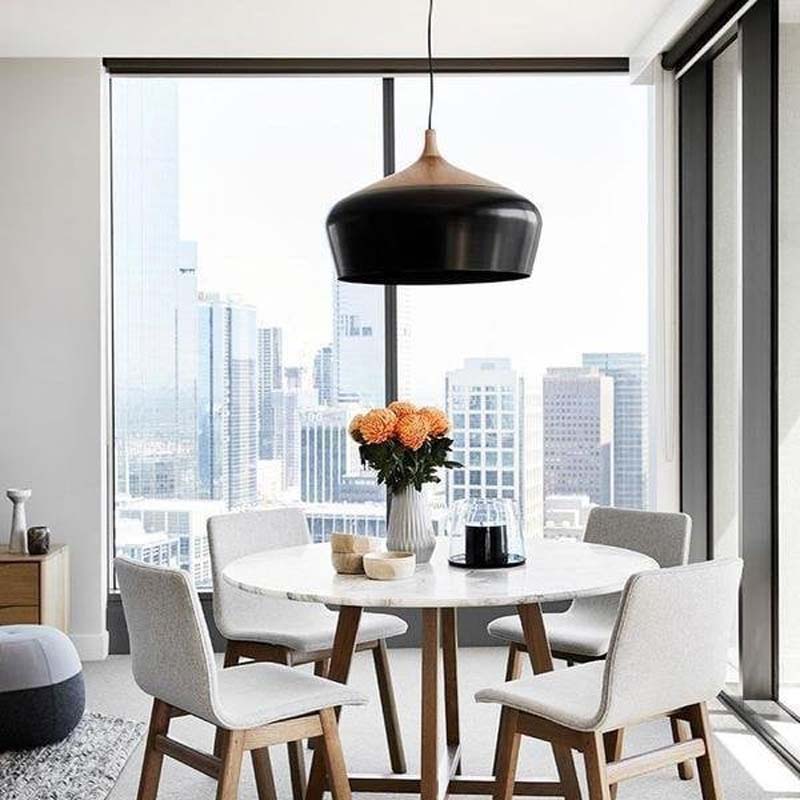 Pendant Lamp Dome in a contemporary dining area with a round table and chairs, featuring a large window overlooking the city.