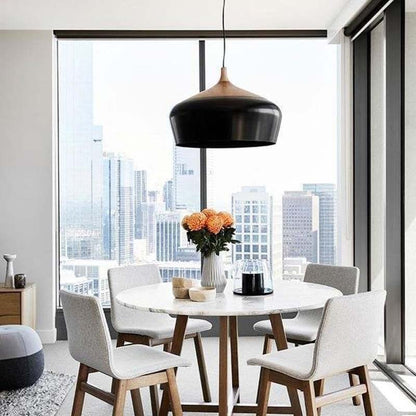 Pendant Lamp Dome in a contemporary dining area with a round table and chairs, featuring a large window overlooking the city.