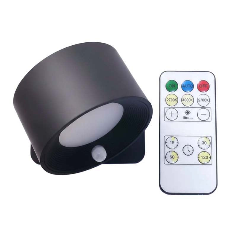 Black lamp with remote control on a white background.