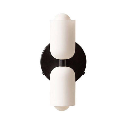 Wall sconce with two white glass shades on a black metal fixture against a white background