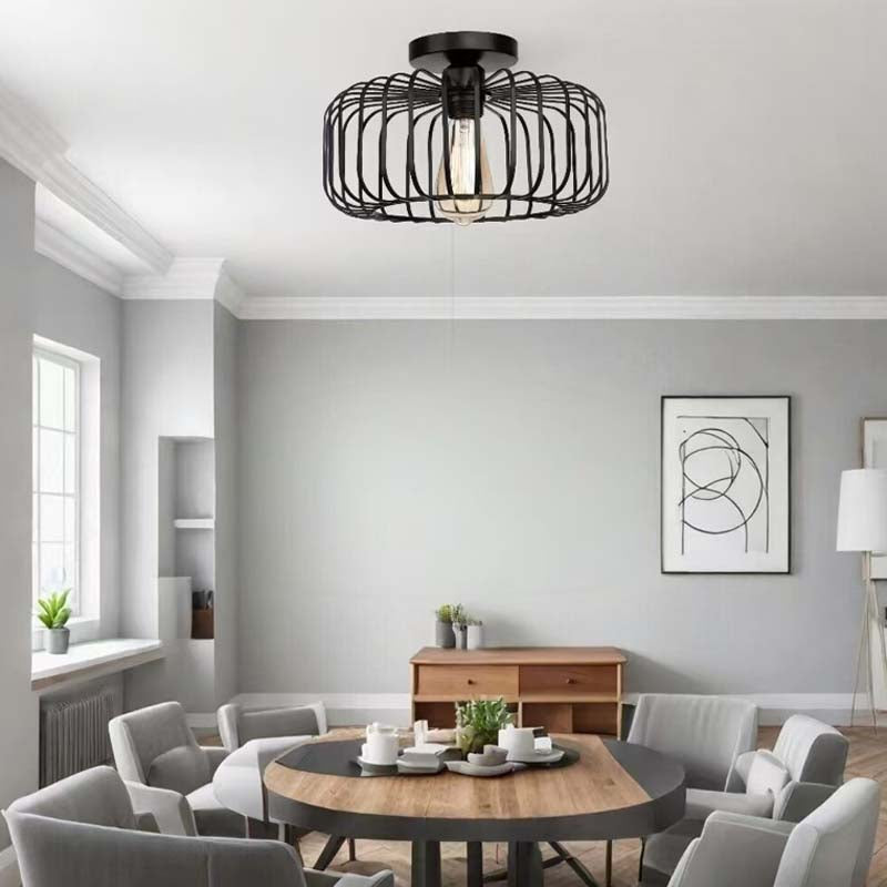 Black ceiling pendant light above a modern dining table.
