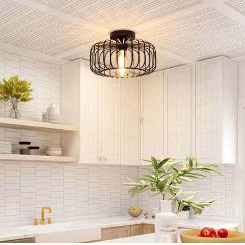 Black pendant light in a modern white kitchen
