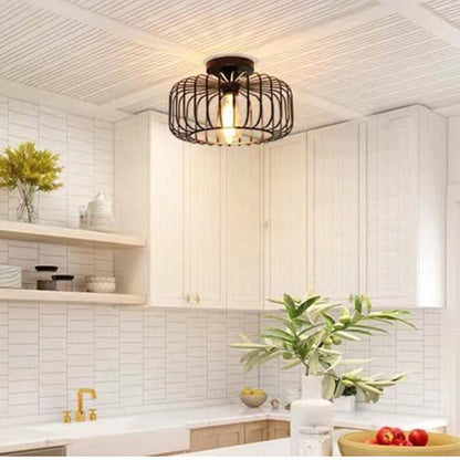 Black pendant light in a modern white kitchen