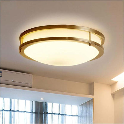 Ceiling light fixture with gold trim in a room with curtains and air conditioner.