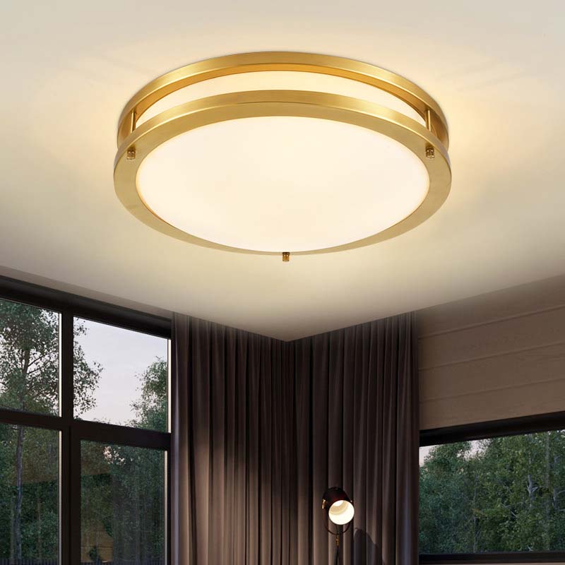 Gold ceiling light fixture in a room with windows and curtains