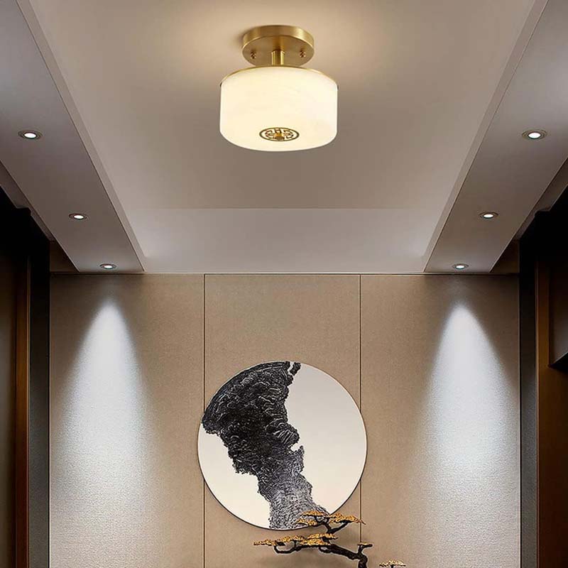 Ceiling light fixture in a room with a wall-mounted sculpture