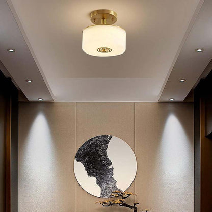 Ceiling light fixture in a room with a wall-mounted sculpture