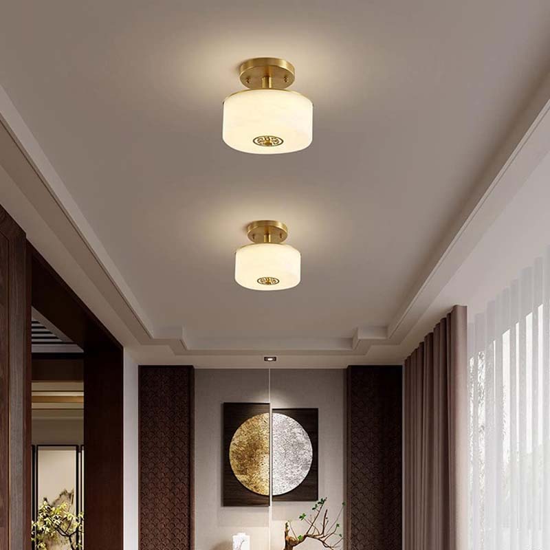 Two ceiling lights in a room with decor elements.