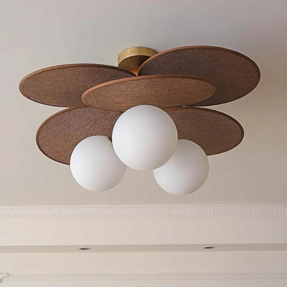 Ceiling light with a raffia lampshade and three spherical glass shades.