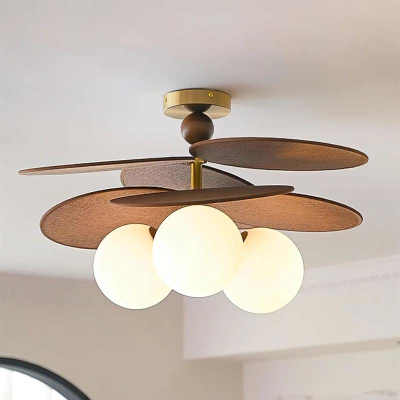 Ceiling light with wooden petal-shaped blades and globe shades.
