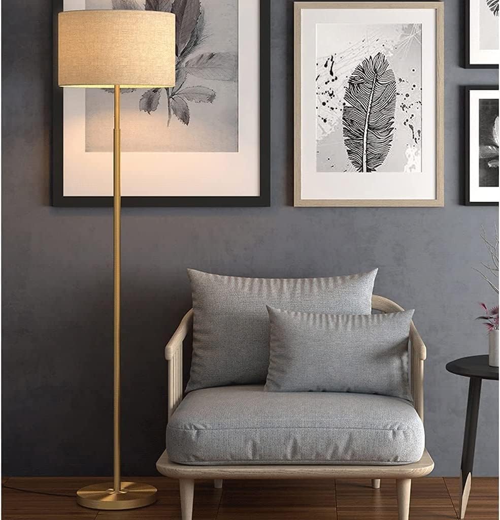 Classic Floor Lamp next to an armchair against a gray wall with paintings