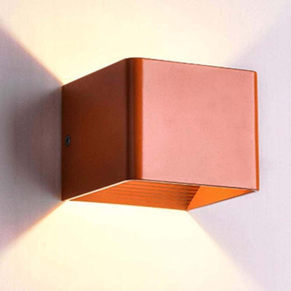Copper wall-mounted light fixture on a white wall