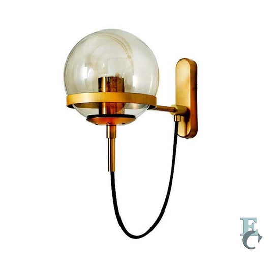 Wall-mounted lamp with gold fixture and clear glass shade on a white background