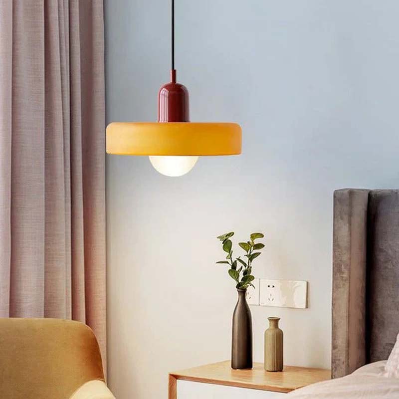 Yellow Color Glow Pendant Light hangs in a room with a bed and curtain.
