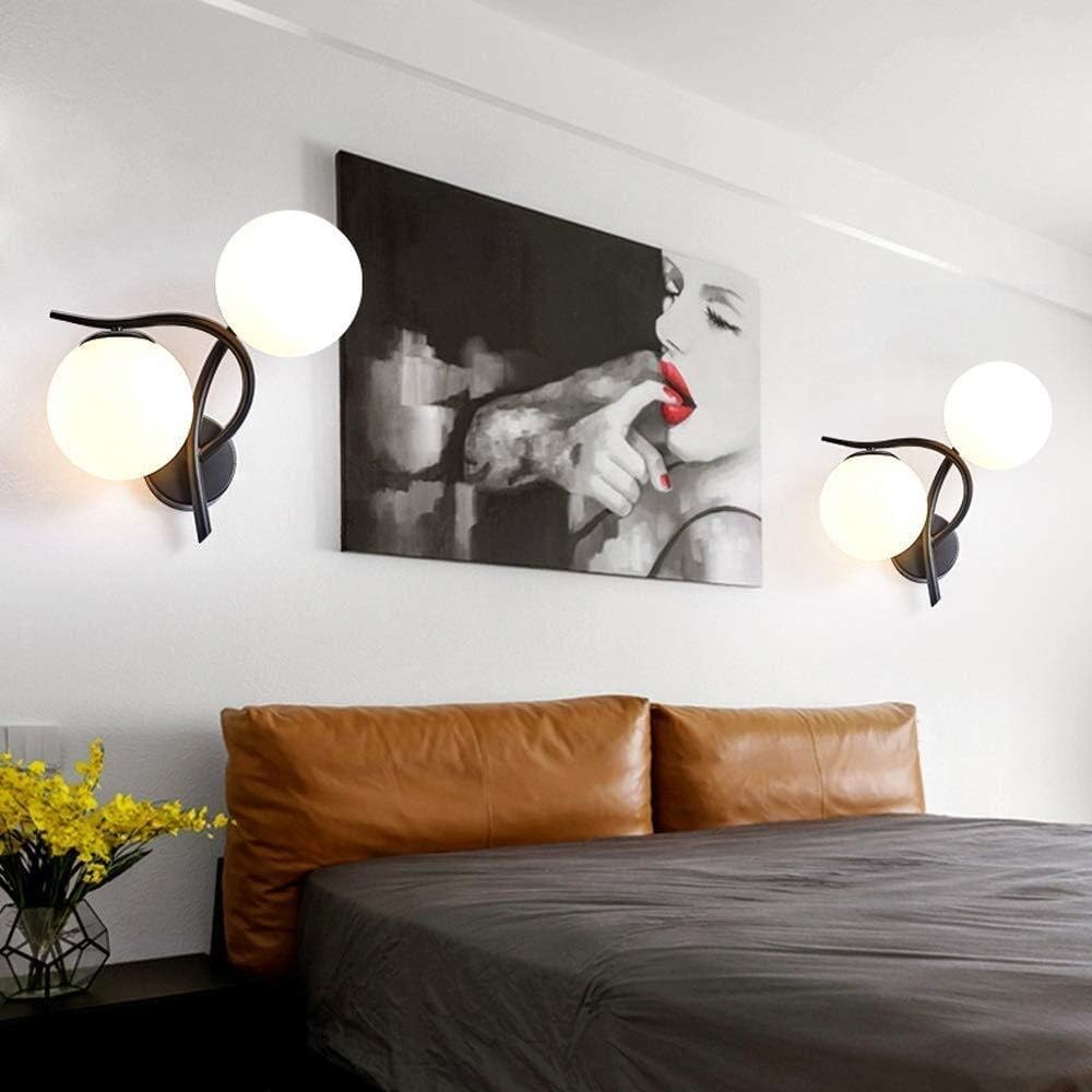 Elegant Two-Sphere Wall Sconce in a modern bedroom with bed, wall art and decorative elements.