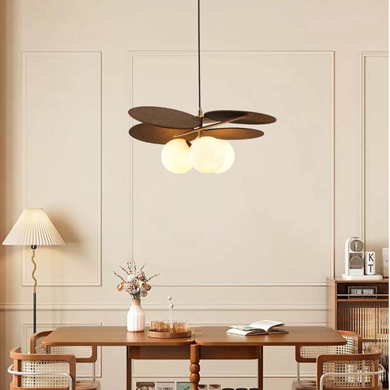 Designer pendant light with wooden elements and soft warm lighting.