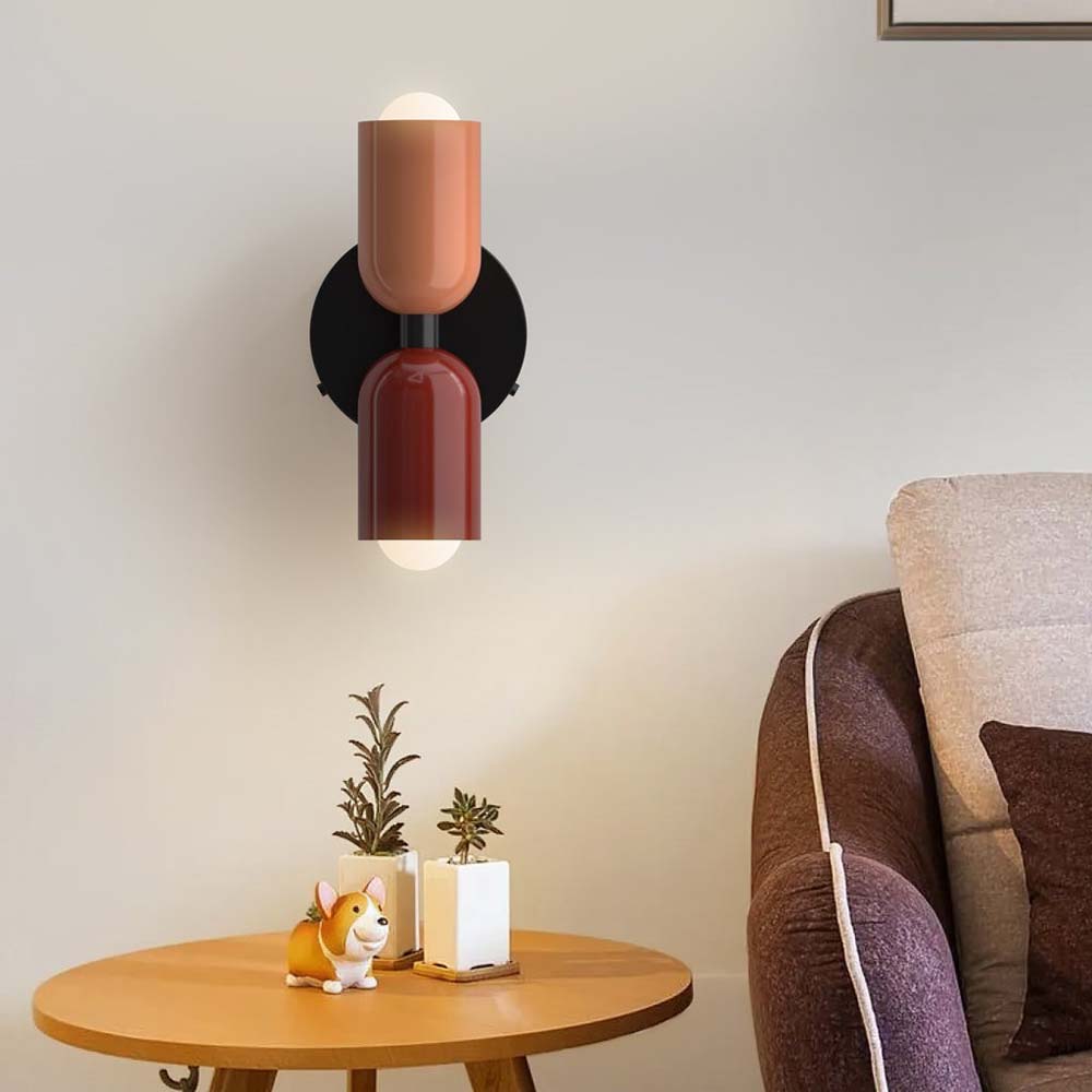 Modern wall sconce with a warm glow in a living room setting.