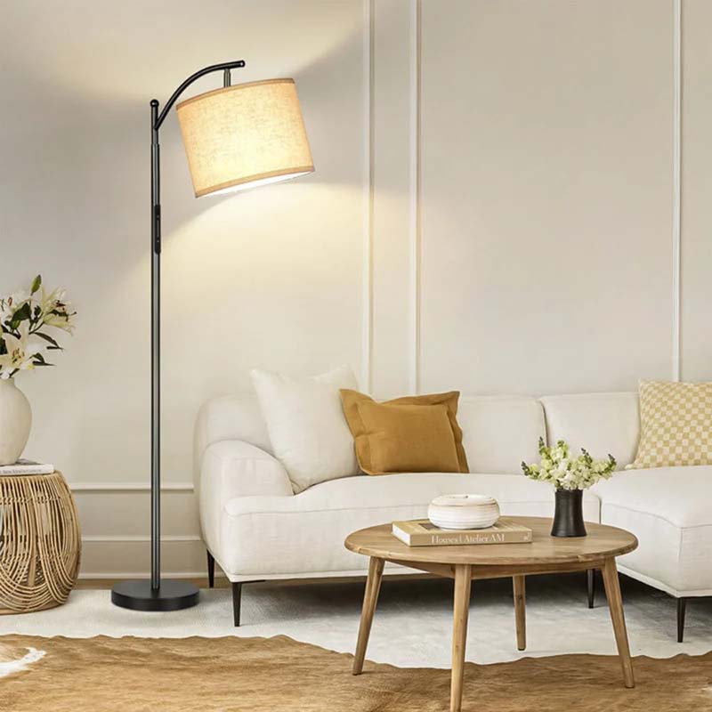 Living room with a white sofa, wooden coffee table, and floor lamp.