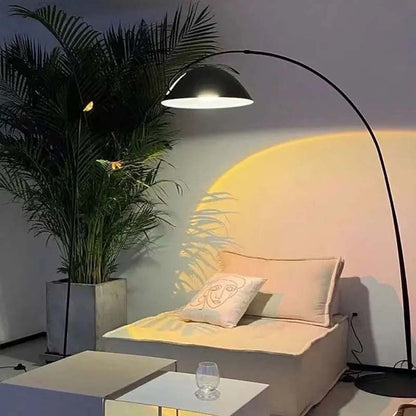 Floor-standing black Bowl floor lamp with a dome-shaped shade above a minimalist sofa and a plant.