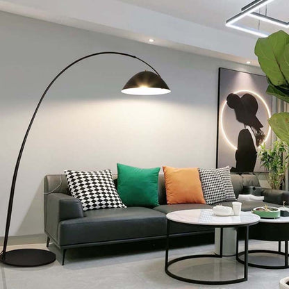 Floor bowl floor lamp with an arched design over a sofa in a modern living room interior.