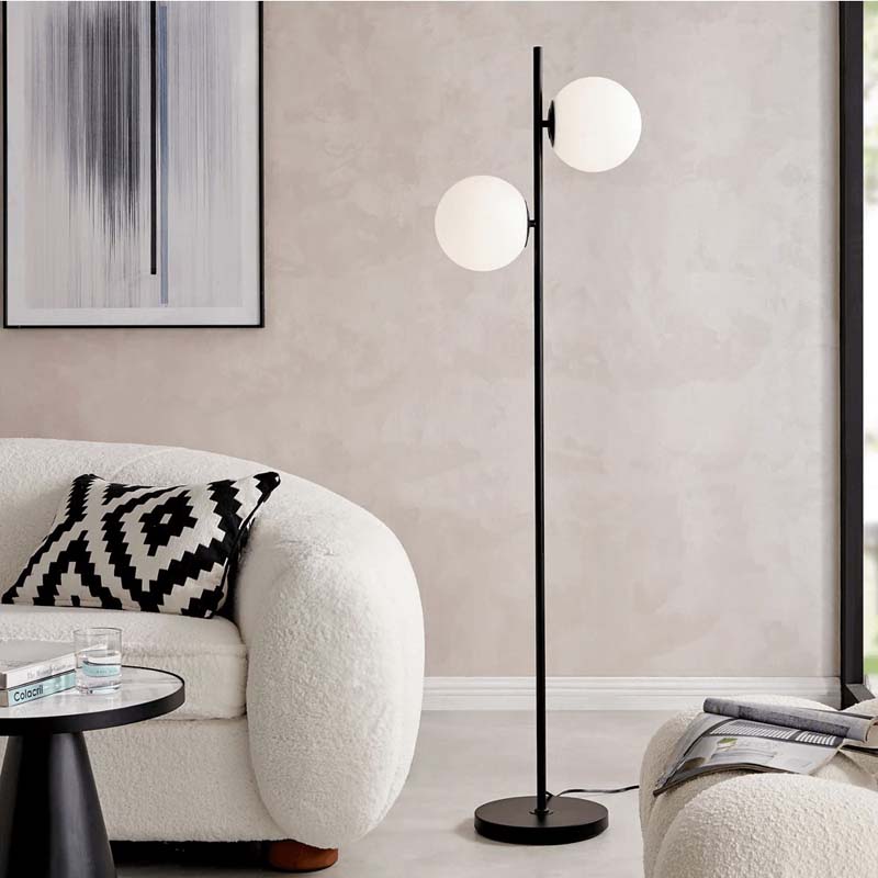Modern living room with a floor lamp, sofa, and abstract art on the wall.