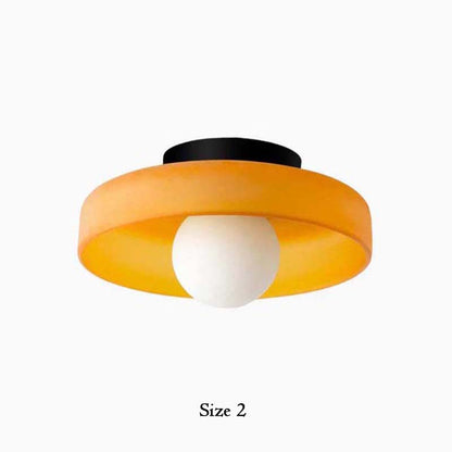 Ceiling light fixture with orange and black design on a white background
