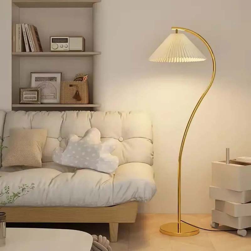 Gold floor lamp next to a white sofa in a living room setting
