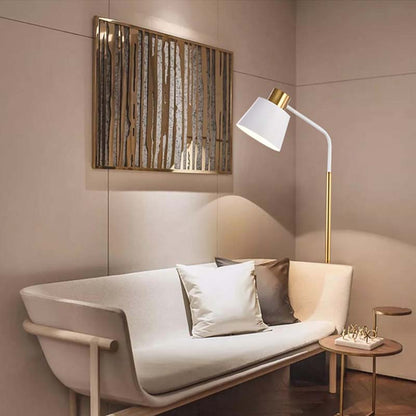 Golden floor lamp in a modern living room with a white sofa and decorative paintings on the walls