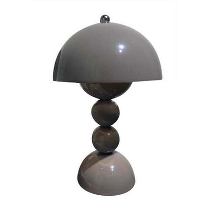 Table lamp with a gray dome shade and three spherical bases on a white background