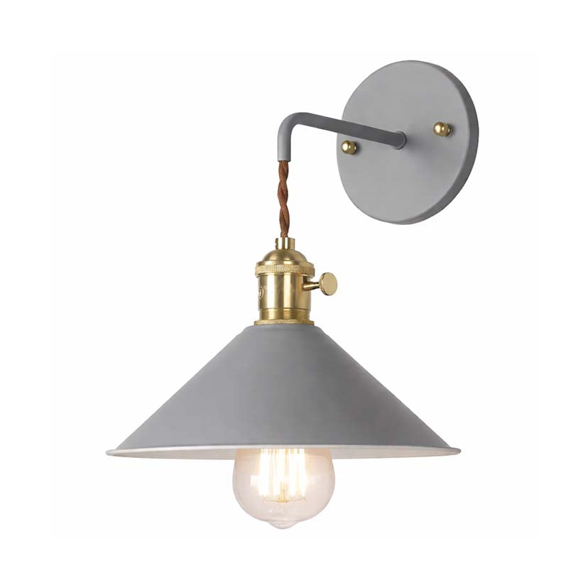 Gray wall sconce with brass accents on a white background