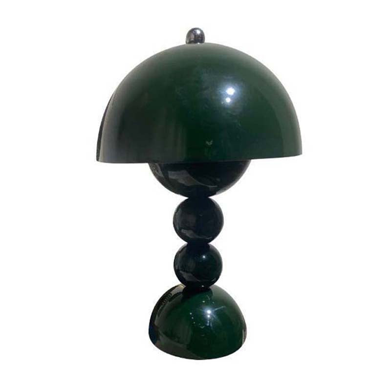 Green table lamp with a unique design on a white background