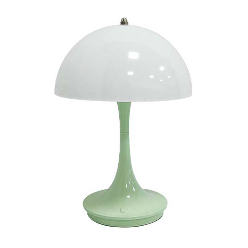 Green table lamp with a white shade on a white background