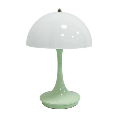 Green table lamp with a white shade on a white background