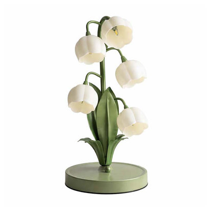 Decorative table lamp with white floral design on a white background