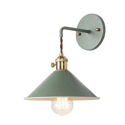 Green wall-mounted lamp with a brass fixture on a white background