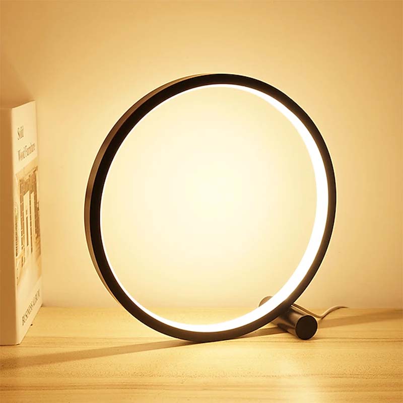 Circular light fixture on a wooden surface with a warm glow