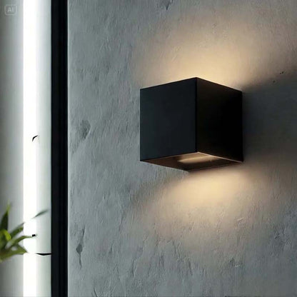 Black square wall light fixture on a textured gray wall